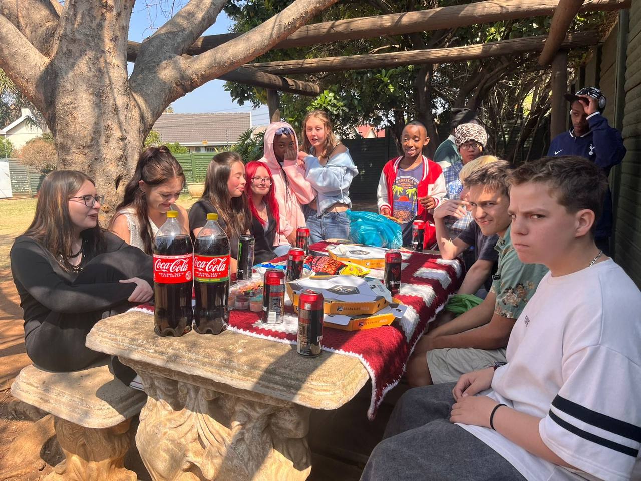 Wide group photo of the Spring Picnic under the pergola
