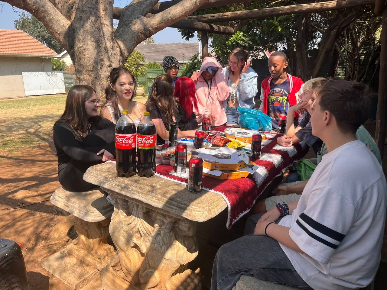 Learners talking around the picnic table at St. Ronald's